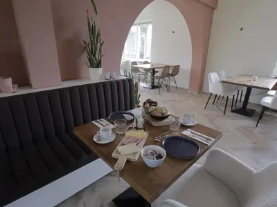 a dining room with a table and a radiator at Hotel Zuideinde in Nieuwkoop