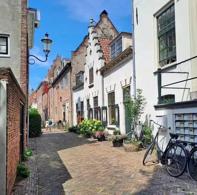 a cobblestone street with buildings and bikes parked on the street at Cozy two-room city center apartment with garden in Amersfoort