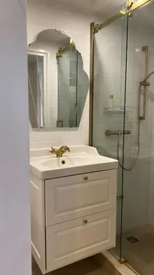 a white bathroom with a sink and a shower at Little Paradise in Zandvoort