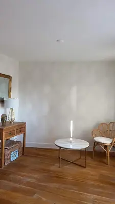 a living room with a table and a chair at Little Paradise in Zandvoort