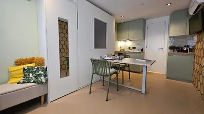 a small kitchen with a table and chairs in a room at Studio Spring - 20 min from Amsterdam Centre - FREE parking in Purmerend