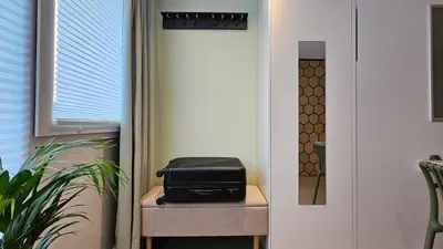 a black briefcase sitting on a stool next to a door at Studio Spring - 20 min from Amsterdam Centre - FREE parking in Purmerend