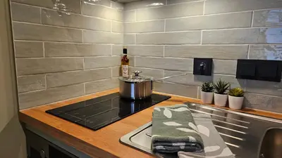 a kitchen with a stove with a pot on it at Studio Spring - 20 min from Amsterdam Centre - FREE parking in Purmerend