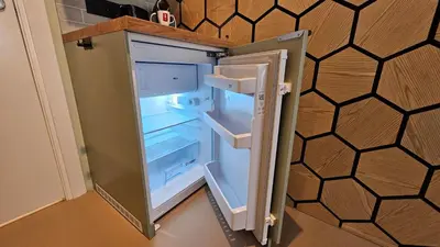 an empty refrigerator with its door open in a kitchen at Studio Spring - 20 min from Amsterdam Centre - FREE parking in Purmerend