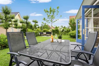 a black table and chairs on a patio at Vakantiepark Schoorlse Duinen in Schoorl