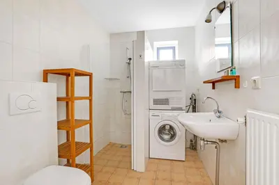 a bathroom with a washing machine and a sink at Vakantiepark Schoorlse Duinen in Schoorl