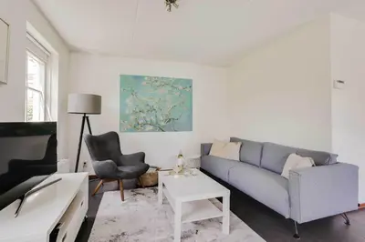 a living room with a couch and a table at Vakantiepark Schoorlse Duinen in Schoorl