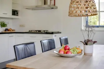 a bowl of fruit on a table in a kitchen at Vakantiepark Schoorlse Duinen in Schoorl