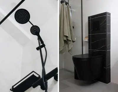 a bathroom with a shower and a black toilet at Guesthouse de Leeuwerik in Haastrecht