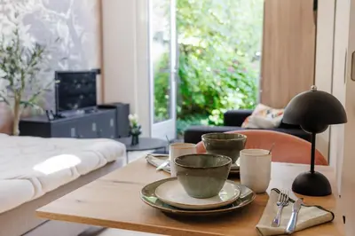 a table with cups and plates on it in a living room at Guesthouse de Leeuwerik in Haastrecht