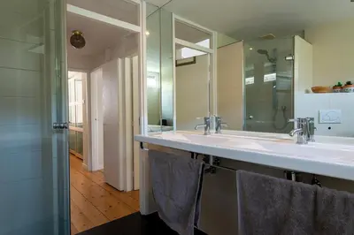 a bathroom with a large sink and a mirror at Huize Zonnebloem in Beverwijk