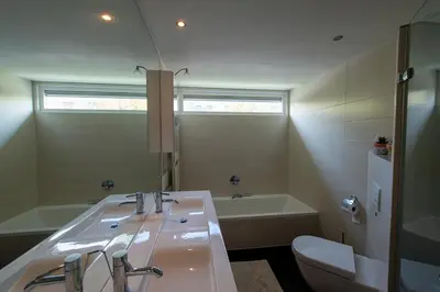 a bathroom with a sink and a tub and a toilet at Huize Zonnebloem in Beverwijk