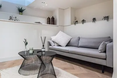 a living room with a couch and a table at Central Luxury Apartment in Amsterdam