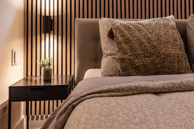 a bedroom with a bed and a table with a pillow at Central Luxury Apartment in Amsterdam