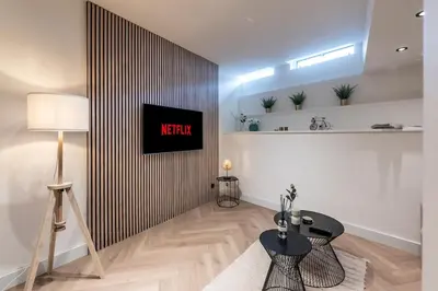 a living room with a television on a wall at Central Luxury Apartment in Amsterdam