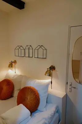 a white couch with two pillows on it in a room at City center Amstel river Houseboat Kom en Zie in Amsterdam