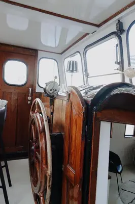 an old wooden car with a wooden wheel on a boat at City center Amstel river Houseboat Kom en Zie in Amsterdam