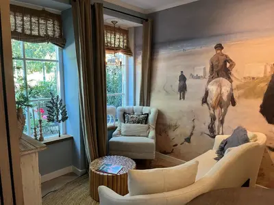 a living room with a large painting on the wall at Strandrit in Groet