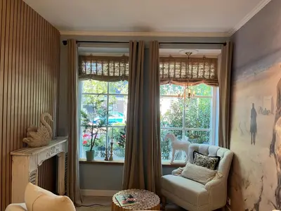 a living room with a chair and a window at Strandrit in Groet
