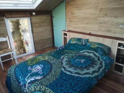 a bedroom with a large bed in a room at Sweet Treehouse in Westbeemster