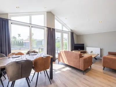 a dining room with a table and some chairs at Karper Vakantiepark De Groote Vliet in Wervershoof