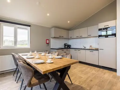 a kitchen with a table and chairs in a room at Karper Vakantiepark De Groote Vliet in Wervershoof