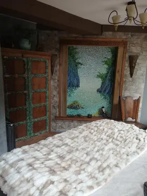 a bed in a room with a painting on the wall at Noorse Viking kamer en suite in Westbeemster