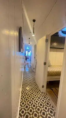a hallway with a room with a floor with black and white tiles at Kust 3 in Egmond aan Zee