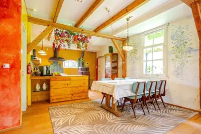 a kitchen with a dining room table and chairs at Reijgershof Art Deco Room with private bathroom in Amsterdam