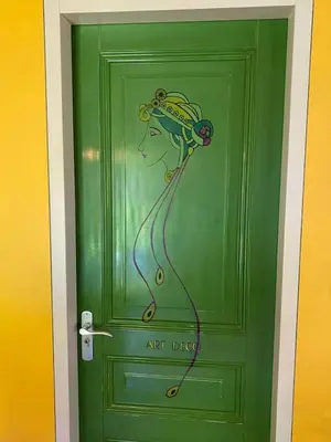 a green door with a painting of a woman on it at Reijgershof Art Deco Room with private bathroom in Amsterdam