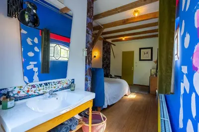 a bathroom with a sink and a bed in a room at Reijgershof Art Deco Room with private bathroom in Amsterdam