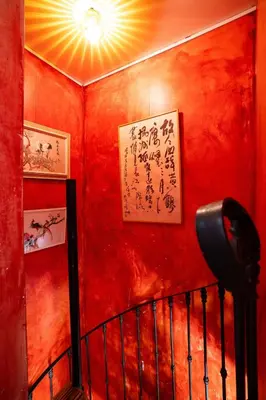 a red wall withinese writing on it at Reijgershof - The Barok lounge in Amsterdam