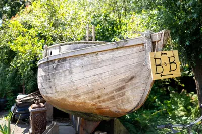 a wooden boat with a sign that reads bbb at Reijgershof - The Barok lounge in Amsterdam