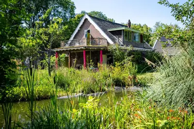 a house with a pond in front of it at Reijgershof - The Barok lounge in Amsterdam