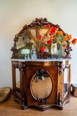 an old wooden table with flowers on top of it at Reijgershof - The Barok lounge in Amsterdam
