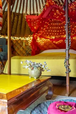 a room with a bed and a vase on a table at Reijgershof - Yurt Experience with garden view in Amsterdam