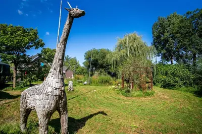 a statue of a giraffe standing in a field at Reijgershof - Bali Suite with private terrace in Amsterdam