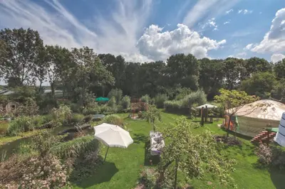 an overhead view of a garden with an umbrella at Reijgershof - Bali Suite with private terrace in Amsterdam