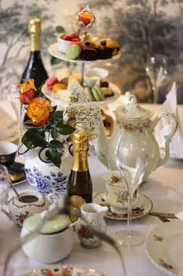 a table topped with dishes and bottles of wine at Hotel Steeds aan Zee in Katwijk
