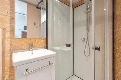 a bathroom with a sink and a shower at Guesthouse De Drukkerij in Zandvoort