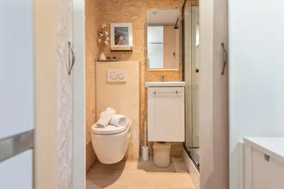a small bathroom with a toilet and a sink at Guesthouse De Drukkerij in Zandvoort