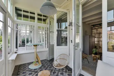 a hallway of a house with a table and chairs at Villa Loft Apartment with Light Garden in Zandvoort