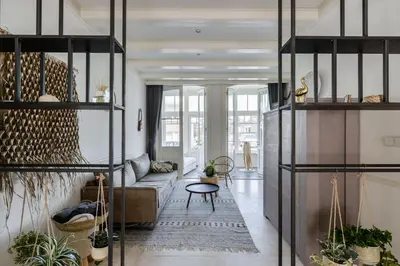a living room with a couch and a table at Villa Loft Apartment with Light Garden in Zandvoort