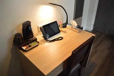 a desk with a laptop and a lamp on it at Hotel Library Amsterdam in Amsterdam