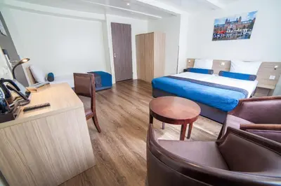 a hotel room with a bed and a living room at Hotel Library Amsterdam in Amsterdam