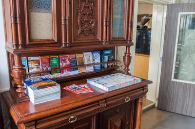 a wooden cabinet with books on top of it at Hotel Library Amsterdam in Amsterdam