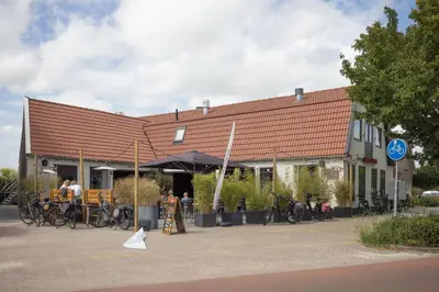 a building with bikes parked in front of it at B&B Het Boompje in Wervershoof