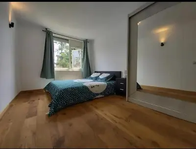 a bedroom with a bed and a large mirror at Villa with garden near Amsterdam in Almere