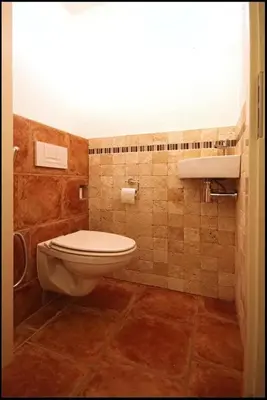 a bathroom with a toilet and a sink at Villa with garden near Amsterdam in Almere