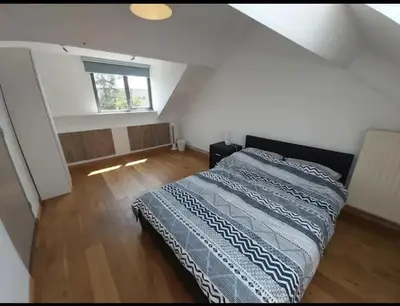 a bedroom with a large bed in a attic at Villa with garden near Amsterdam in Almere